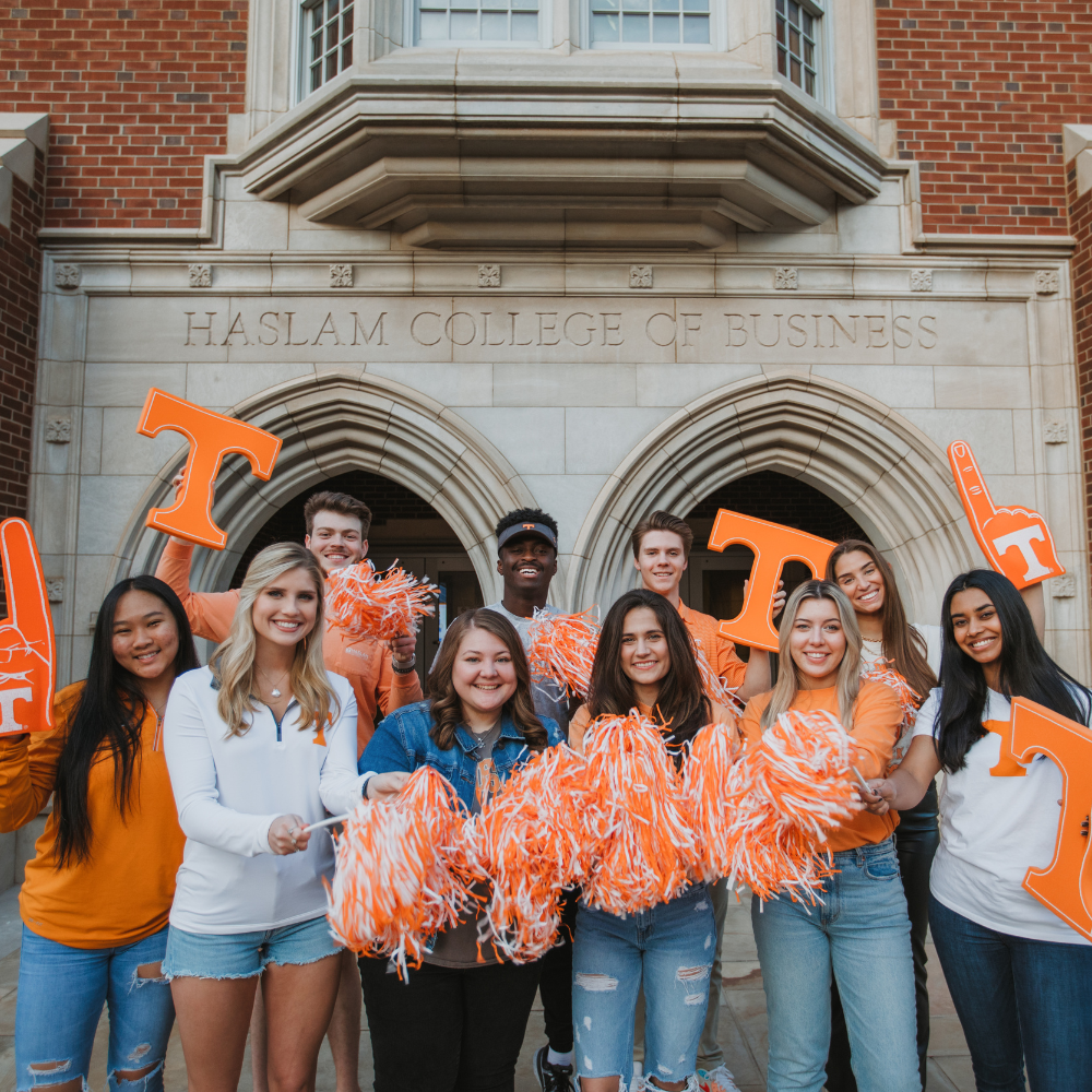 Students smiling in front of the Haslam College of Business